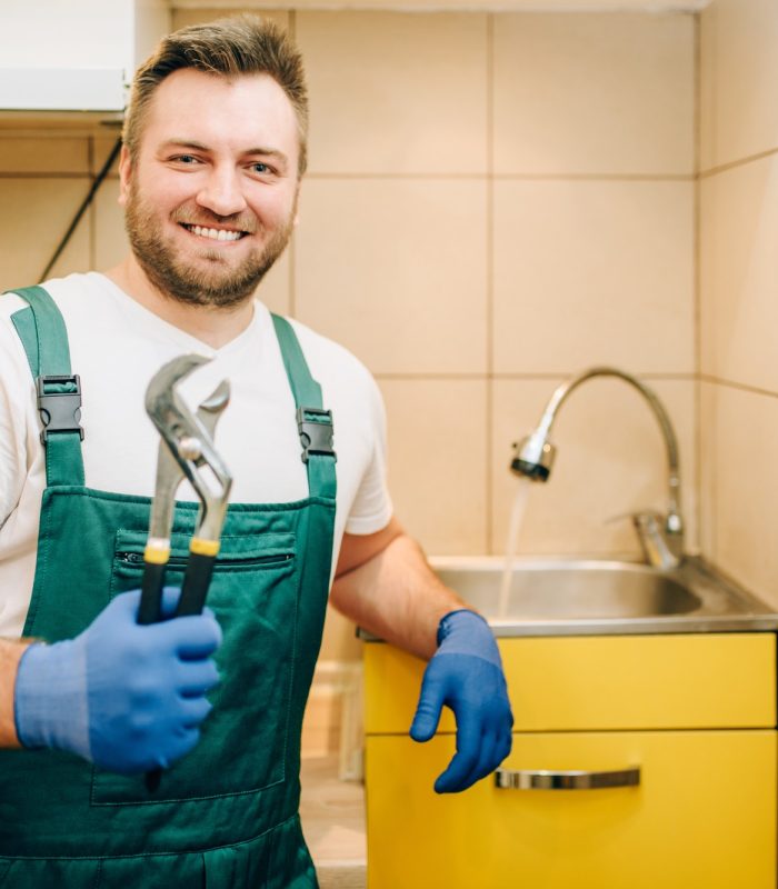 plumber-in-uniform-holds-wrench-handyman.jpg