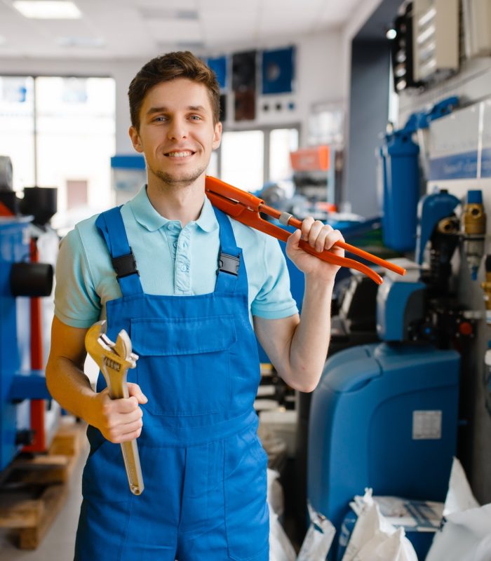 plumber-shows-pipe-wrenches-in-plumbering-store.jpg